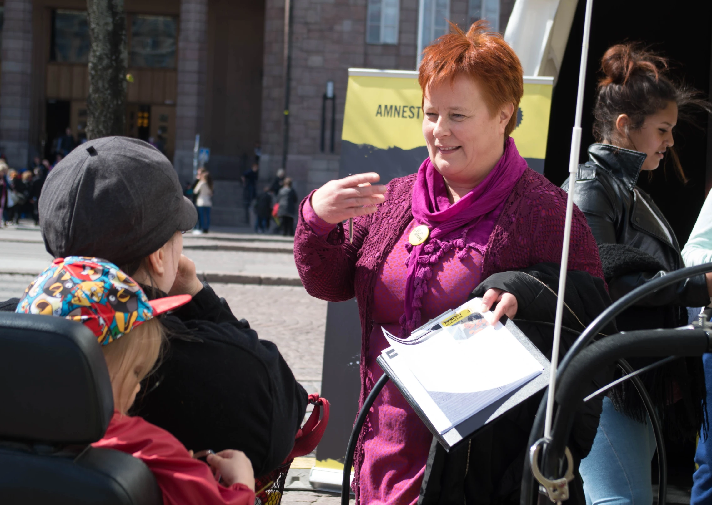 a woman standing next to another woman on the street