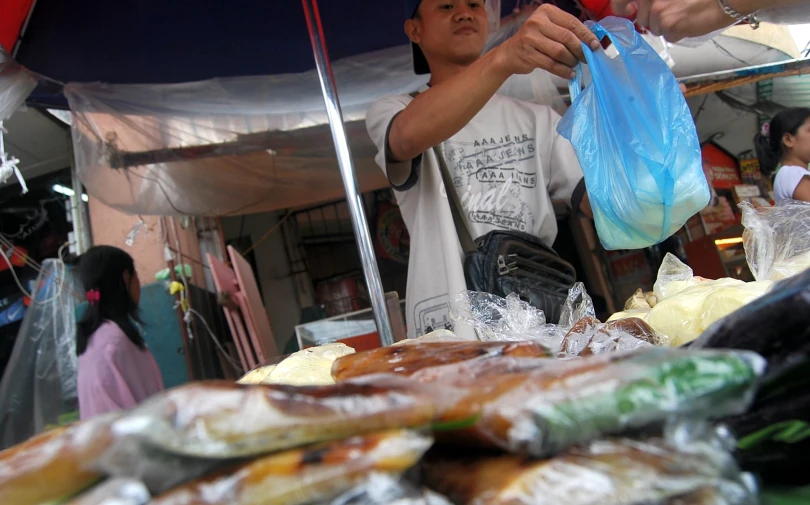 a man with an umbrella is selling food