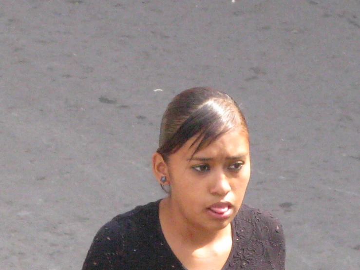 a woman on a cell phone while wearing earrings