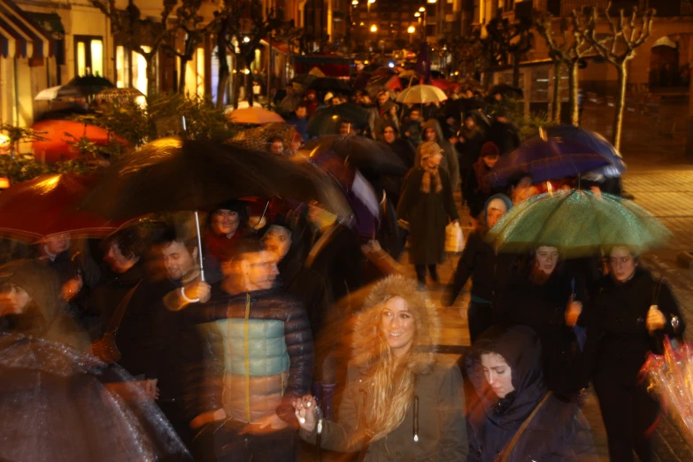 the woman are holding umbrellas in the rain