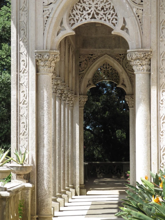columns and arches form an intricate entrance to a garden