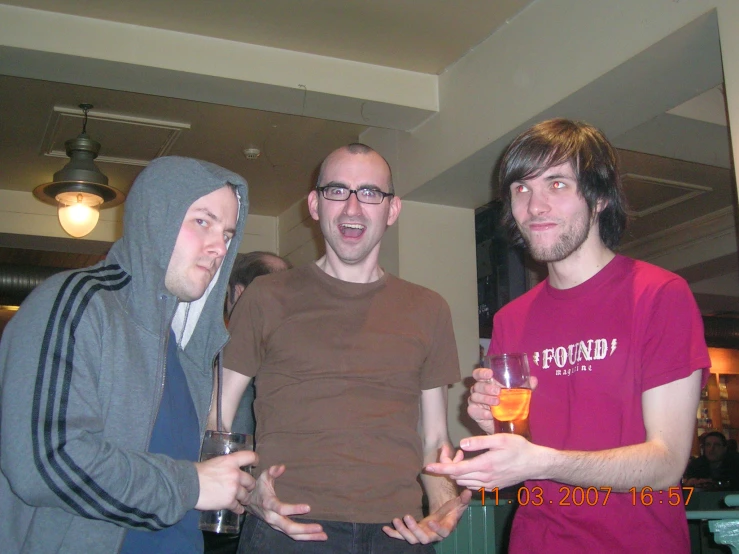 three young men with glasses are standing together