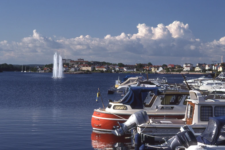 many boats are moored at the marina in front of buildings