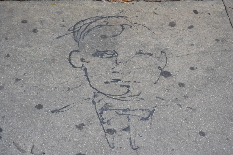 a drawing of a  in the sidewalk