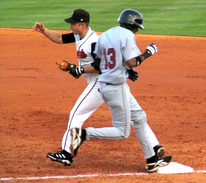 two baseball players in action on the field
