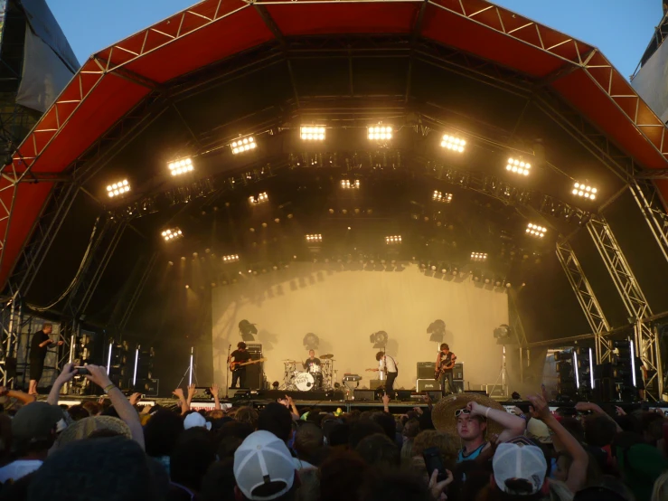 large crowd at an outdoor concert in front of big lights