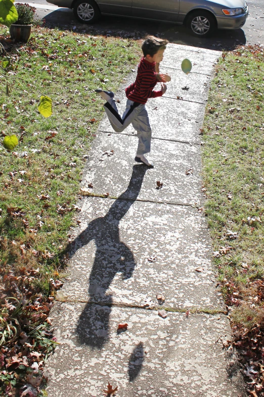 the young child is playing baseball outside