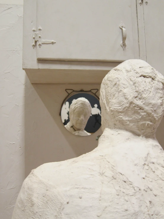 the large stone sculpture is next to the mirror