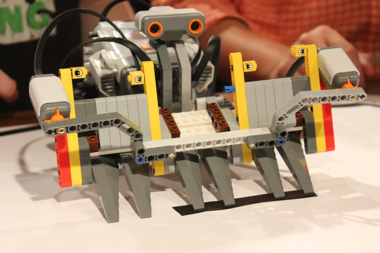 lego robot with two legs attached to it