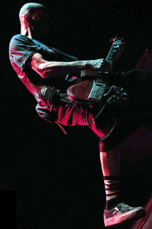 a man performs a hand stand on a stage