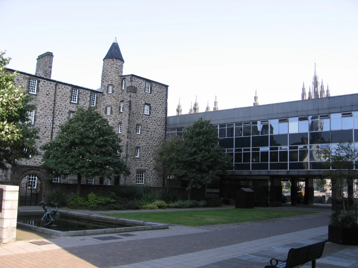 a building with a fountain and benches outside