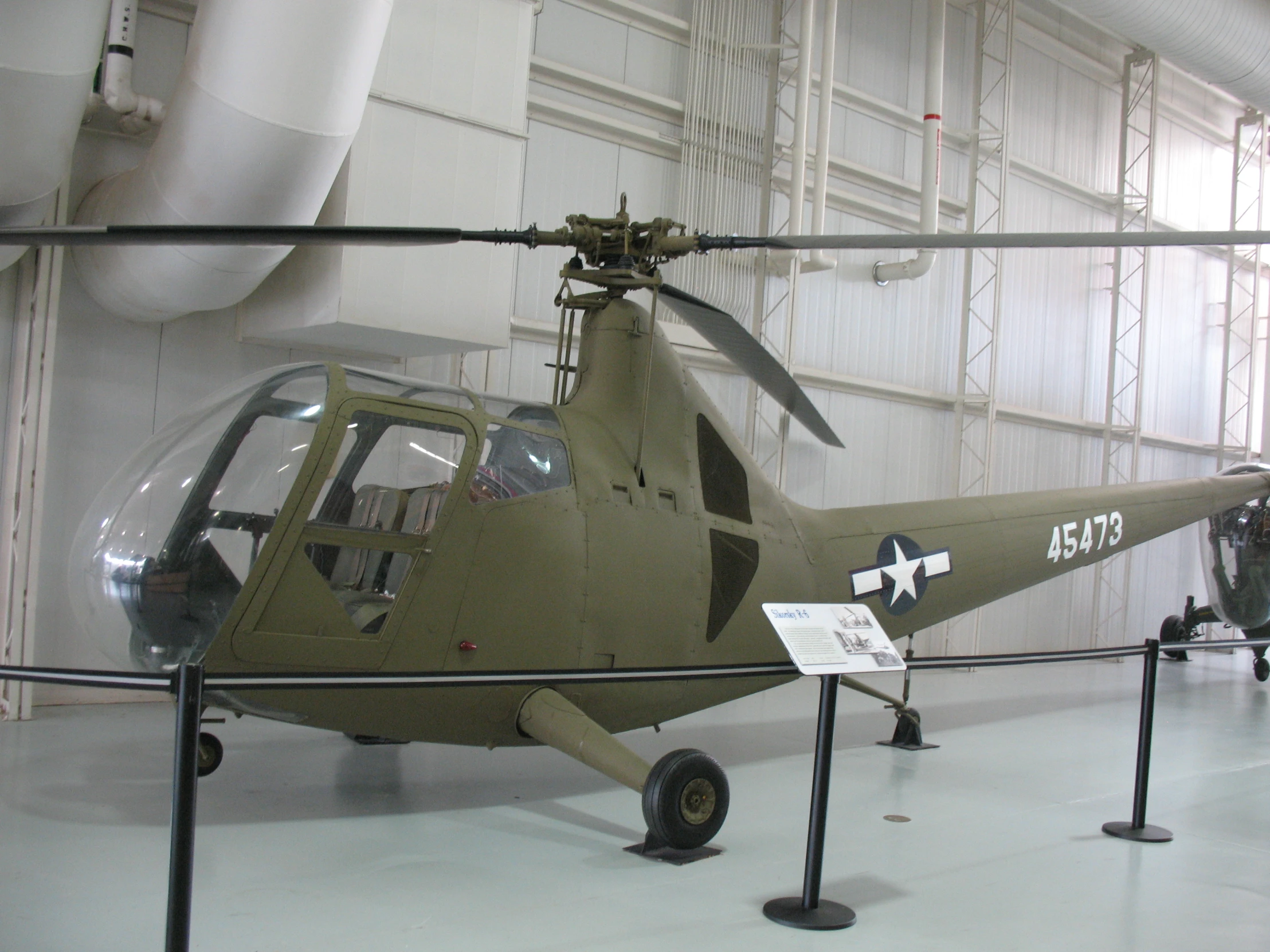 military helicopter on display at indoor museum exhibit
