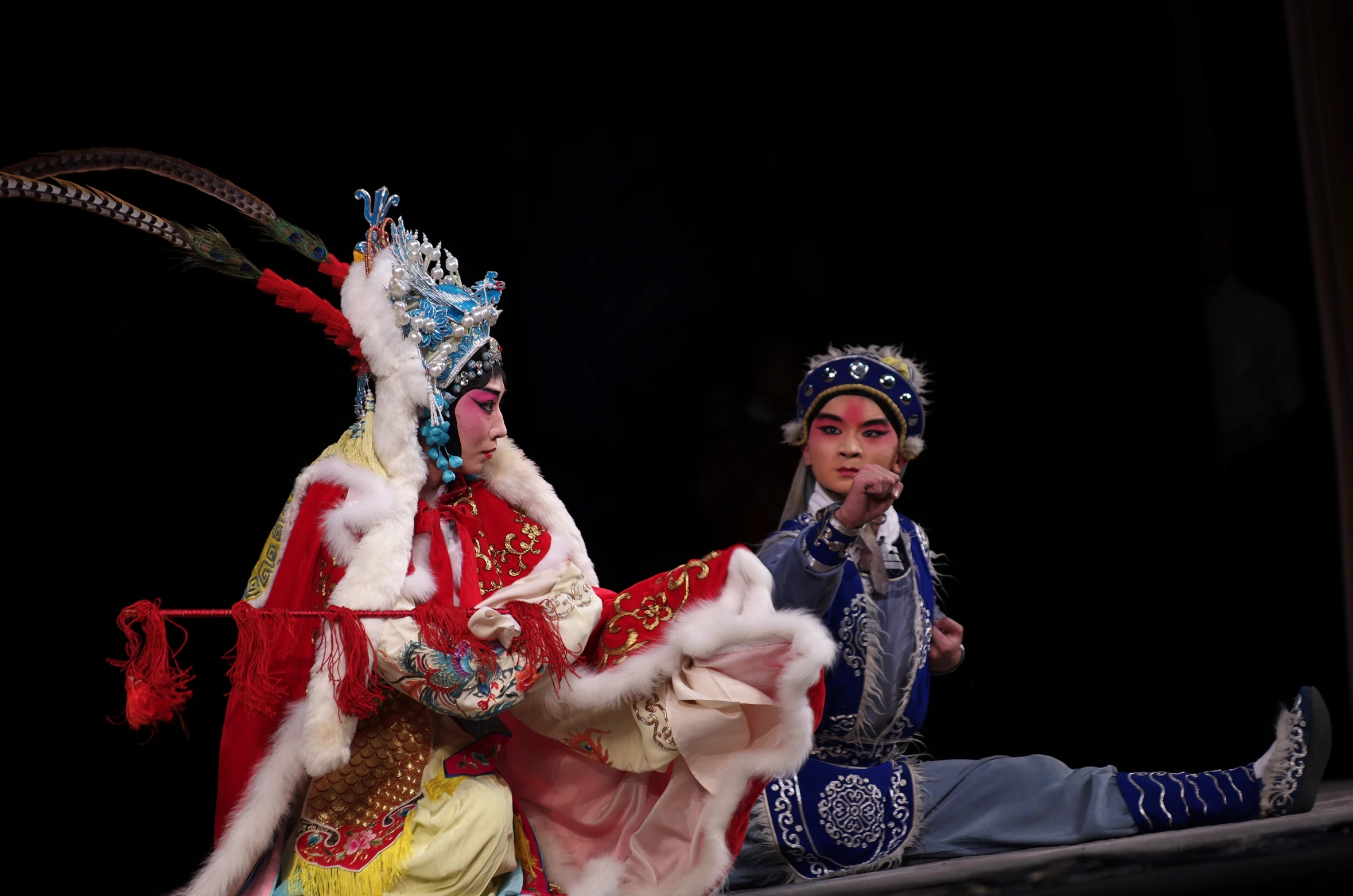 two men are dressed up and performing on stage
