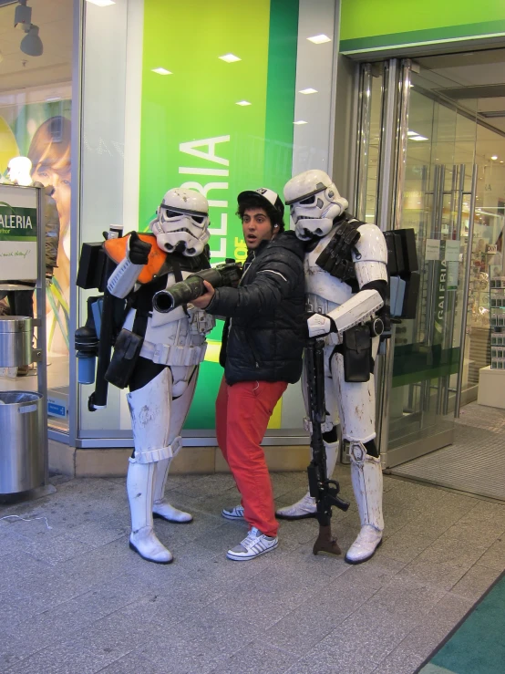 two woman and a boy with stormtrooper costumes
