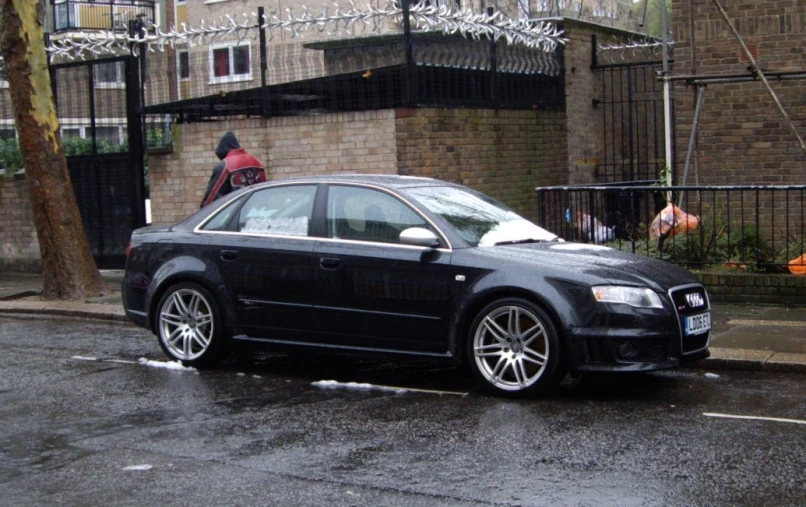a black audi s4 on the side of a road