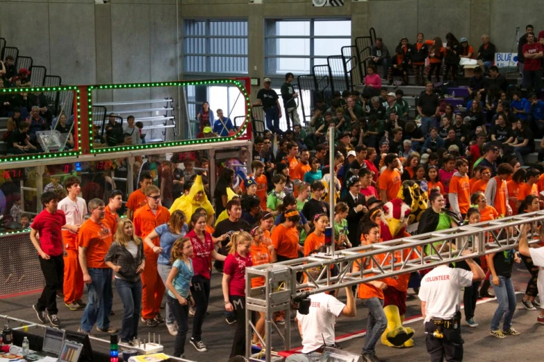 some people in orange and yellow uniform on a street