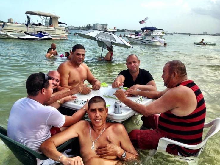 a group of men playing cards in a lake