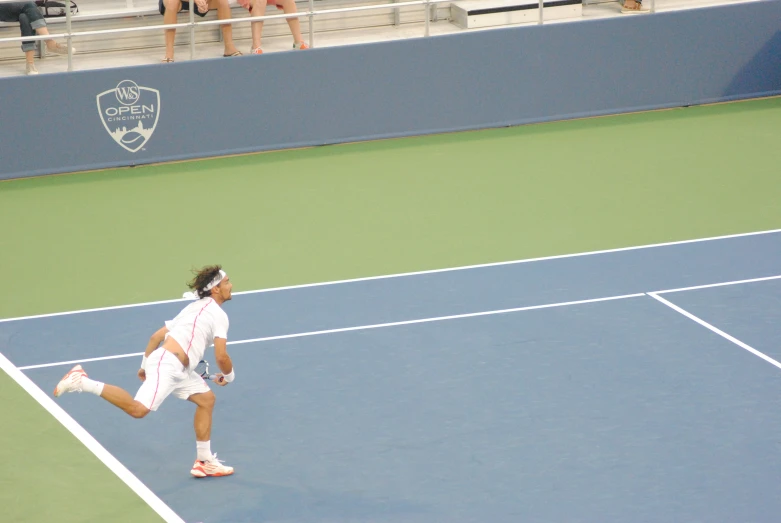 a tennis player is running on the court