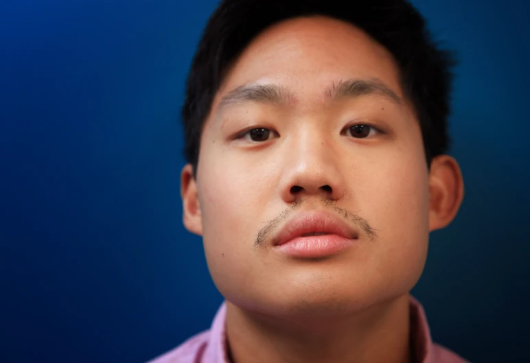 a close up of a man with an interesting mustache