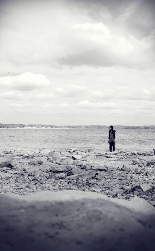 two people standing together in a vast open field