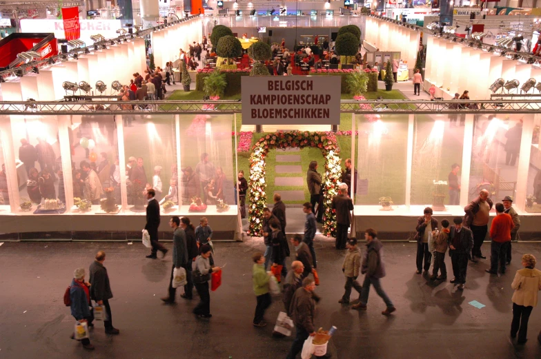 a crowded shopping mall is adorned with christmas lights