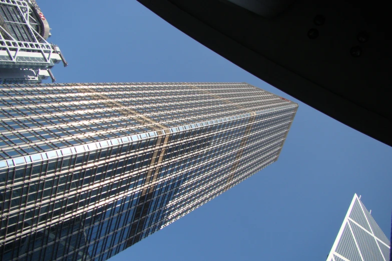 the view from inside a vehicle looking at tall buildings