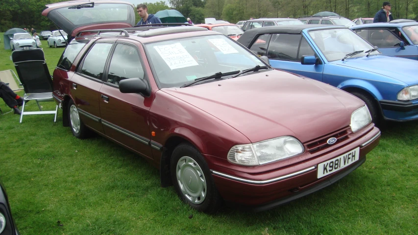 several vehicles are sitting in the grass for sale