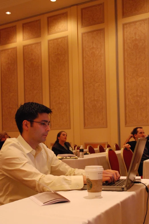 a man on a laptop at a meeting