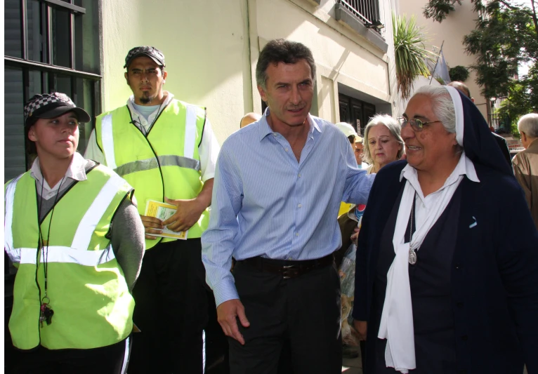 two men shake hands while wearing safety vests