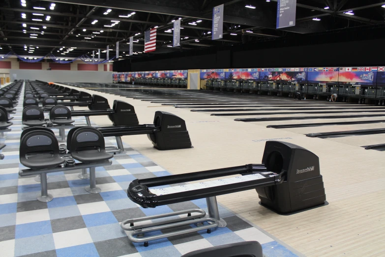 empty seats lined up in a bowling alley