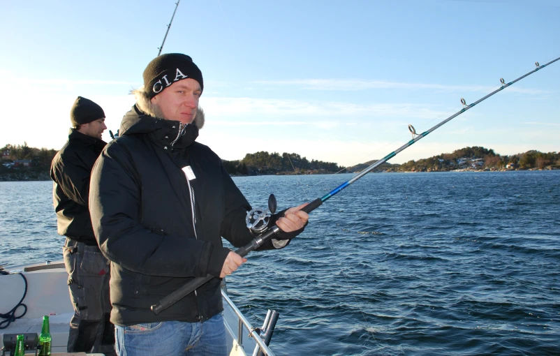 a man holding onto a fishing rod while he fish