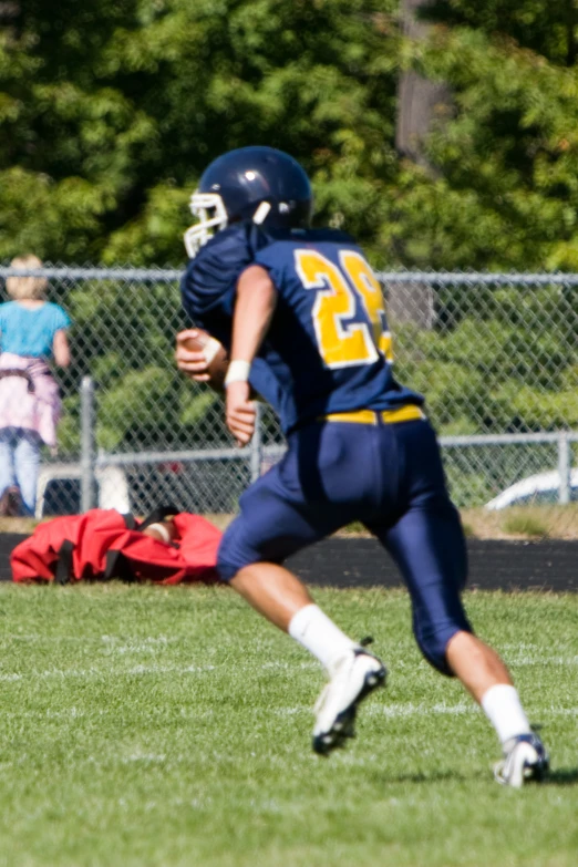 a young man in a football game about to kick the ball