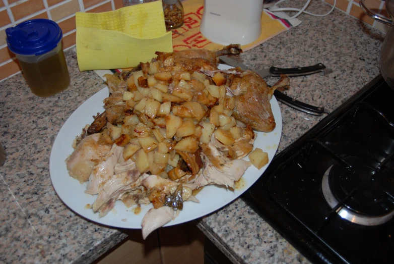 the food is covered with chicken, potatoes, and raisins