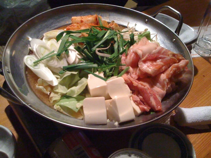 food is in a silver bowl on a table