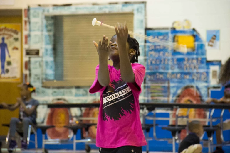 a little girl is holding a white object in her hand