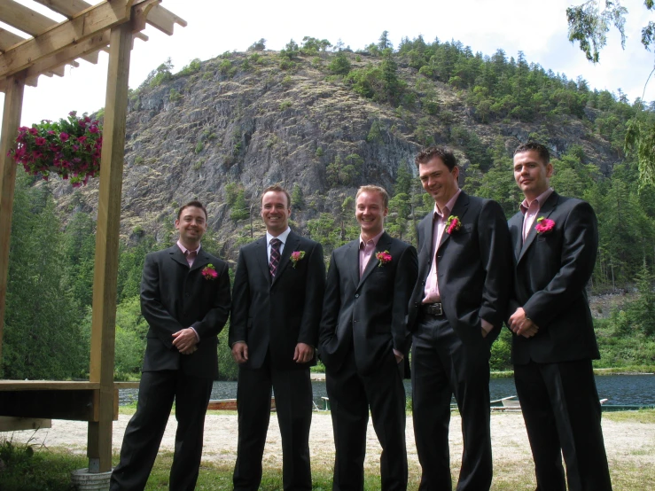 there are six men standing together in black suits