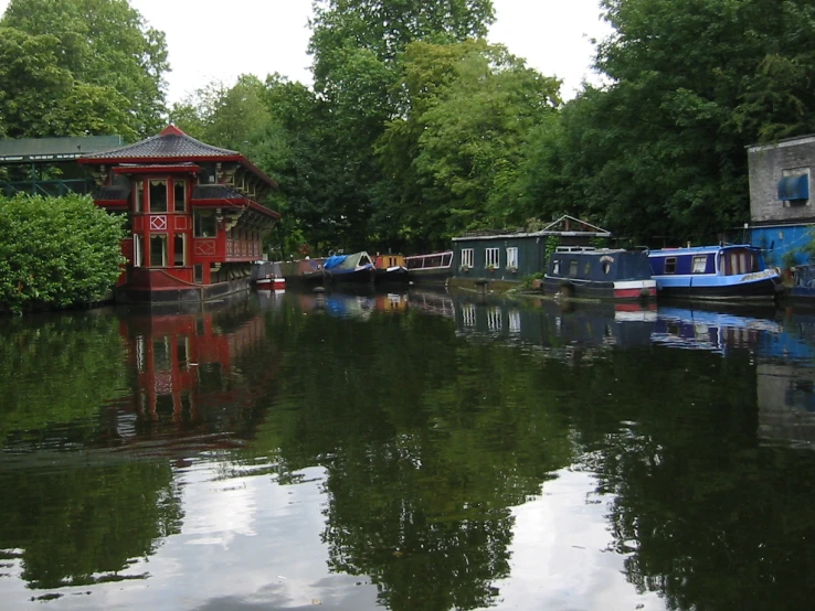 some water boats and trees water buildings and a bridge