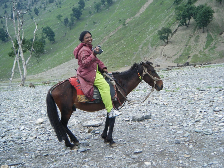 a woman that is sitting on top of a horse