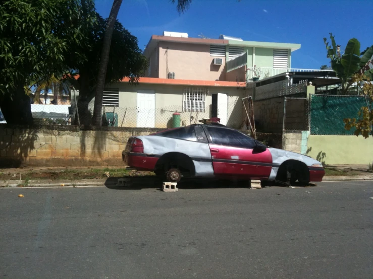 a car painted with a racing pattern parked in front of a house