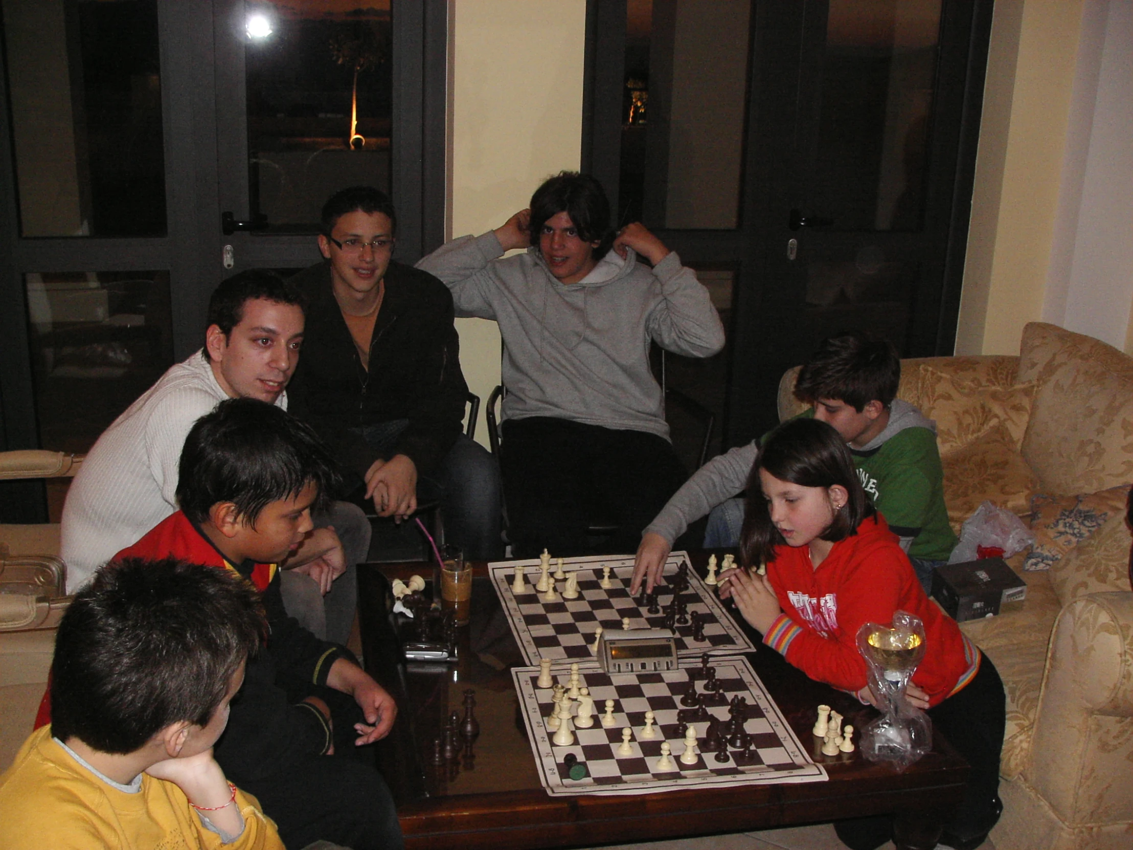 a group of young men playing checkers on a chess board