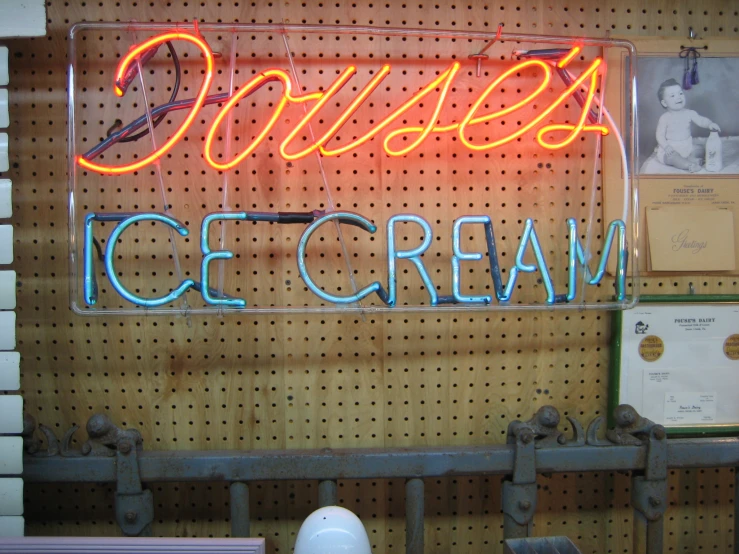 the neon sign reads frozen ice cream