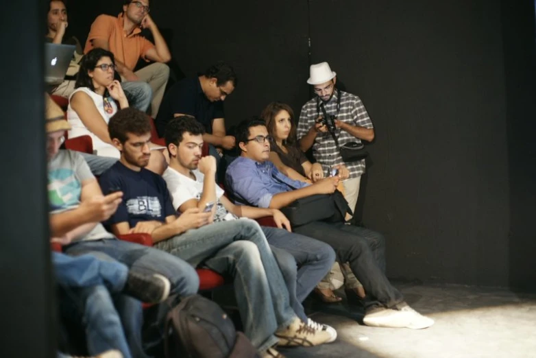 a group of people watching soing at a stage