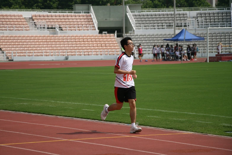 a male athlete is running on the running track