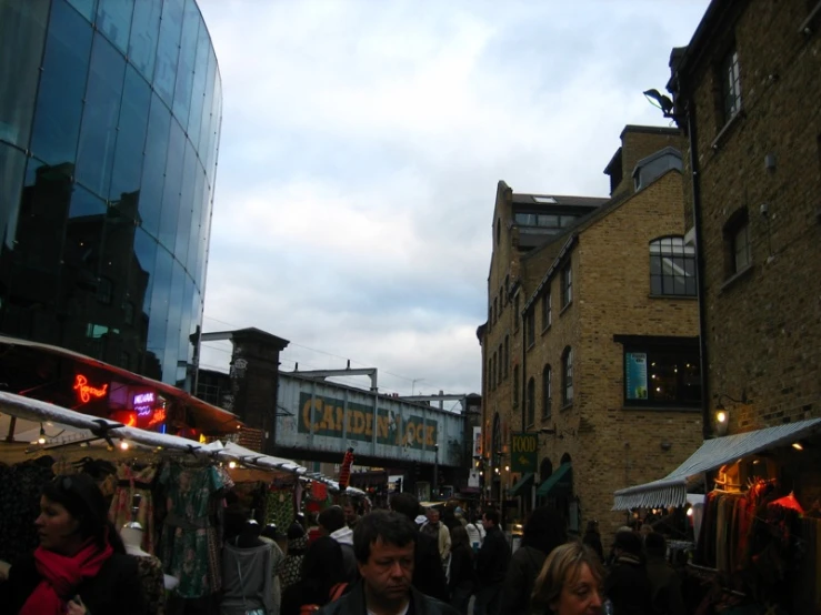 people on a busy outdoor market by a building