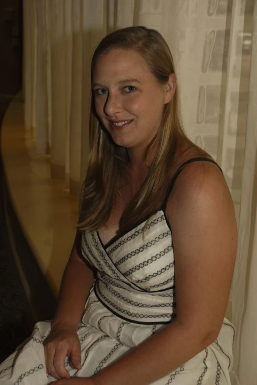 a woman with long hair sitting in a chair