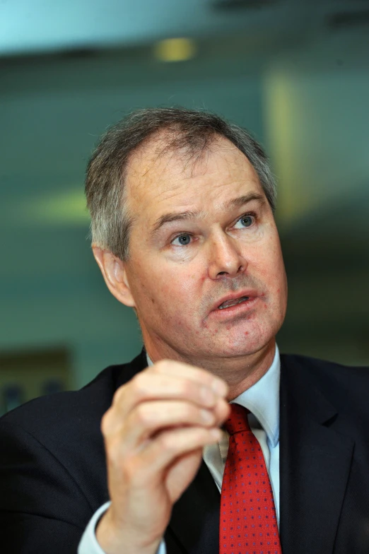 a man in a suit with a red tie