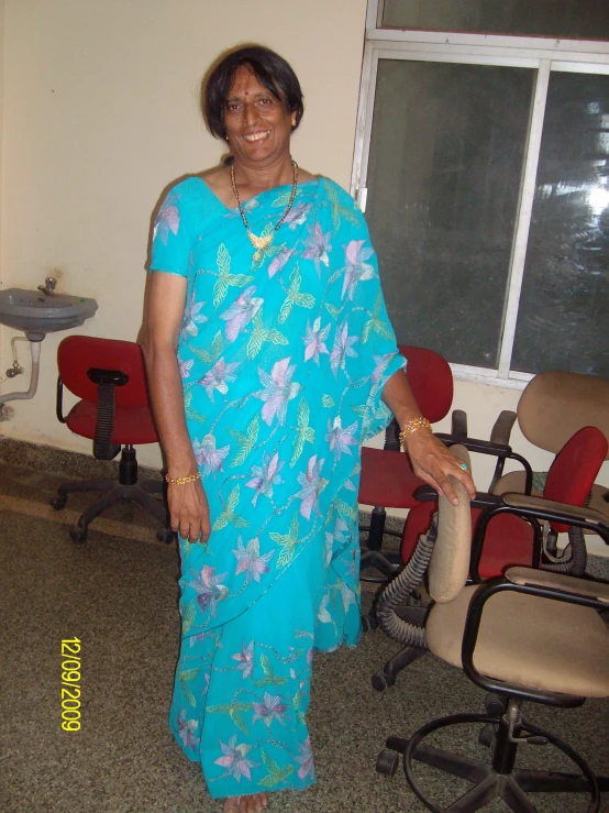 a woman standing in front of a desk chair