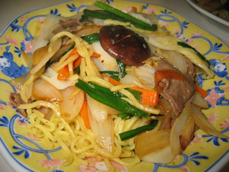this stir fried food has noodles, meat and vegetables