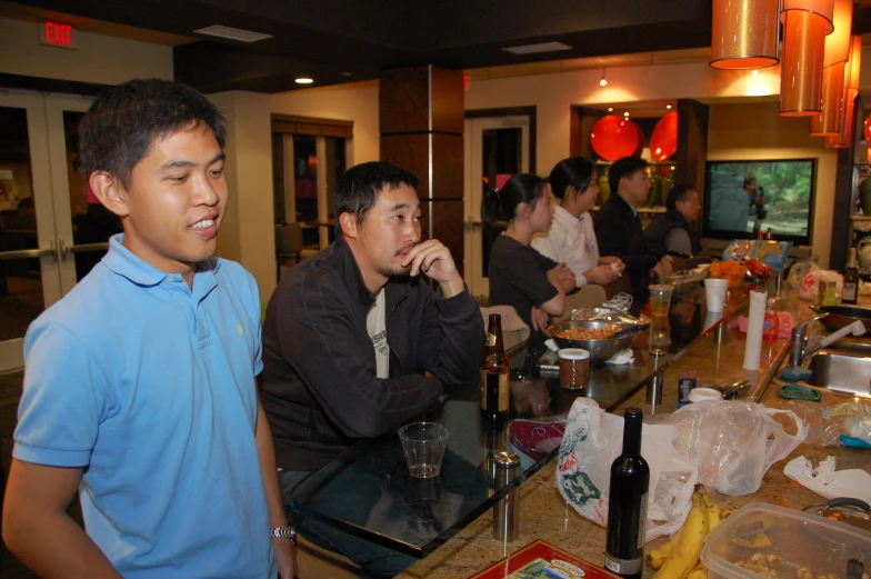 three men are in the restaurant enjoying a meal