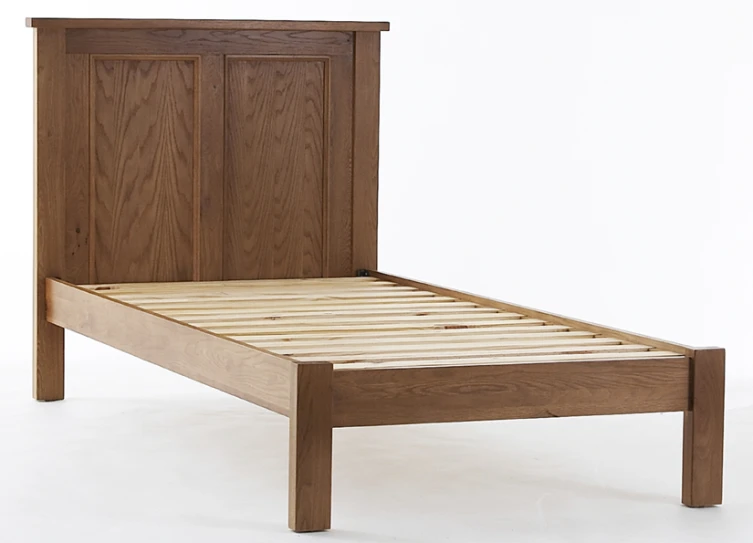 a wooden bed frame with wooden headboard and foot board